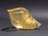 an image of a yellow glass shell on a black surface