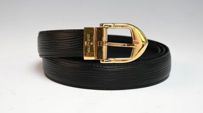 a close up of a black belt with a gold buckle