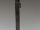 a metal cross on a stand with a cross on it