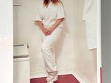 a magazine with a picture of a woman standing in a bathroom