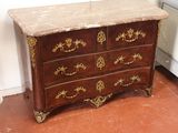 a marble top chest of drawers in the corner of a room