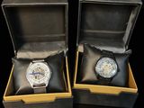 pair of watches in a box on a black surface