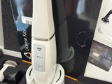 a white electric toothbrush sitting on top of a black table