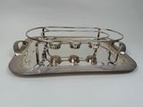 silver plated serving tray with four cups and saucers on it