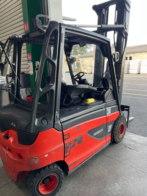 a red fork truck parked in front of a building