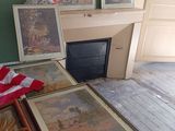 a room with a fire place and pictures on the wall