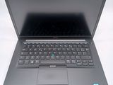 a laptop that is open on a white surface
