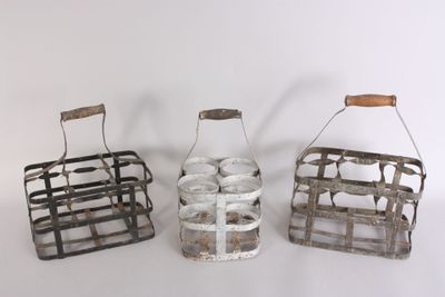 three small metal baskets with wooden handles on a white surface