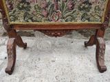 a bench with a tapestry on it on a stone floor