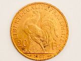 an image of a gold coin with a rooster on it