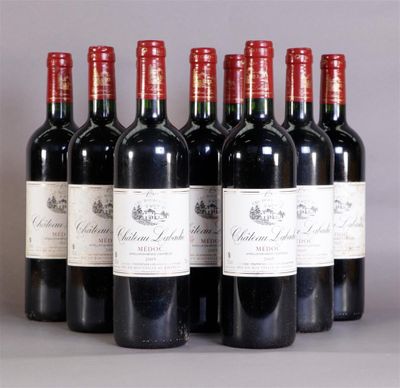 six bottles of red wine are lined up in a row