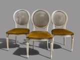 three white chairs with a brown seat and a brown cushion