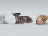 three figurines of animals sitting next to each other