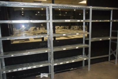 many shelves that are in a room with a lot of shelves