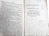 an old book that is open on a table