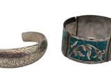 two silver cuff bracelets with blue and green designs