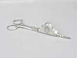 a pair of scissors sitting on top of a white table
