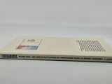 the book is sitting on a white surface with a white background
