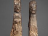 pair of carved wooden figures of a man and a woman