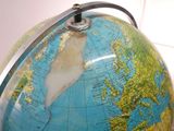 a close up of a globe with a clock on it