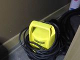 a yellow blow dryer sitting on the floor next to a black bag