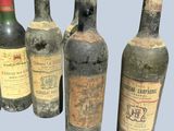 several bottles of wine are lined up in a row on a blue background