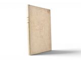 an old book sitting on top of a white table next to a white wall