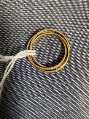 un gros plan sur deux bagues en or posées sur un tissu bleu