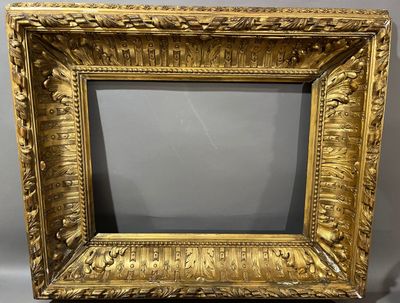 a gold picture frame with a picture of a man and a woman