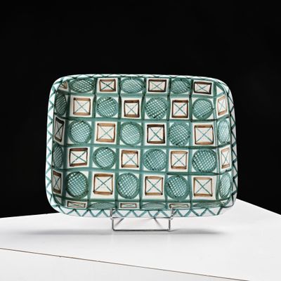 a green and white tray with a pattern on it