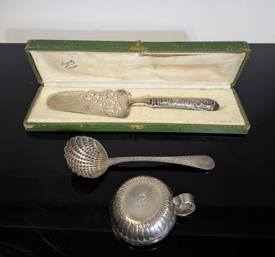 a silver spoon and a spoon rest in a box