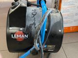 a black and blue machine sitting on a tile floor