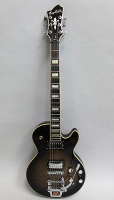 a close up of a black guitar on a white background