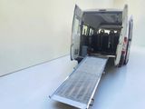 a white van with a ramp attached to the back of it