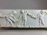 a white and gold plate with a picture of a group of people