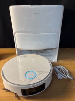 an image of a white robot vacuum sitting on top of a wooden table