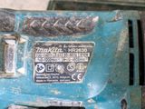 a blue drill that is sitting on top of a table