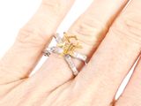 a woman ' s hand that has a ring on it