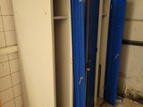 three stalls in the bathroom with blue curtains on them