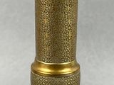 an antique brass vase with a decorative design on the base
