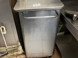 a trash can sitting in the middle of a kitchen