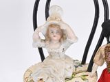 three dolls sitting on a chair next to each other
