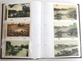 an open book with pictures of a river and a boat