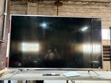 a flat screen tv sitting on top of a wooden table