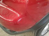 a red scooter that is parked in a garage