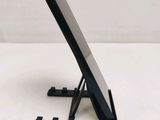 a black tablet on a stand on a white surface