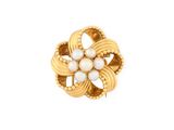 a close up of a gold ring with pearls on a white background