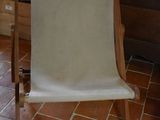 a chair that is sitting in a room by a window