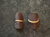 two pieces of chocolate sitting on a counter top