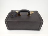 a black suitcase with a handle on a white surface